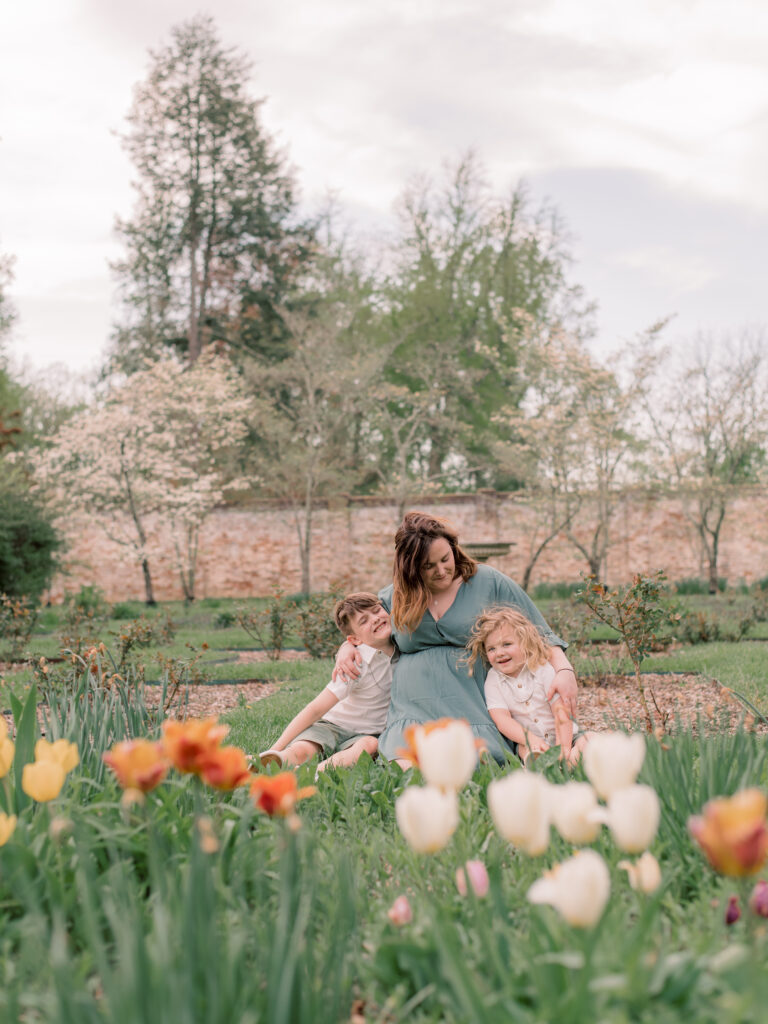 Mom and two boys cuddling in a field of tulips at Chatham Manor in Virignia