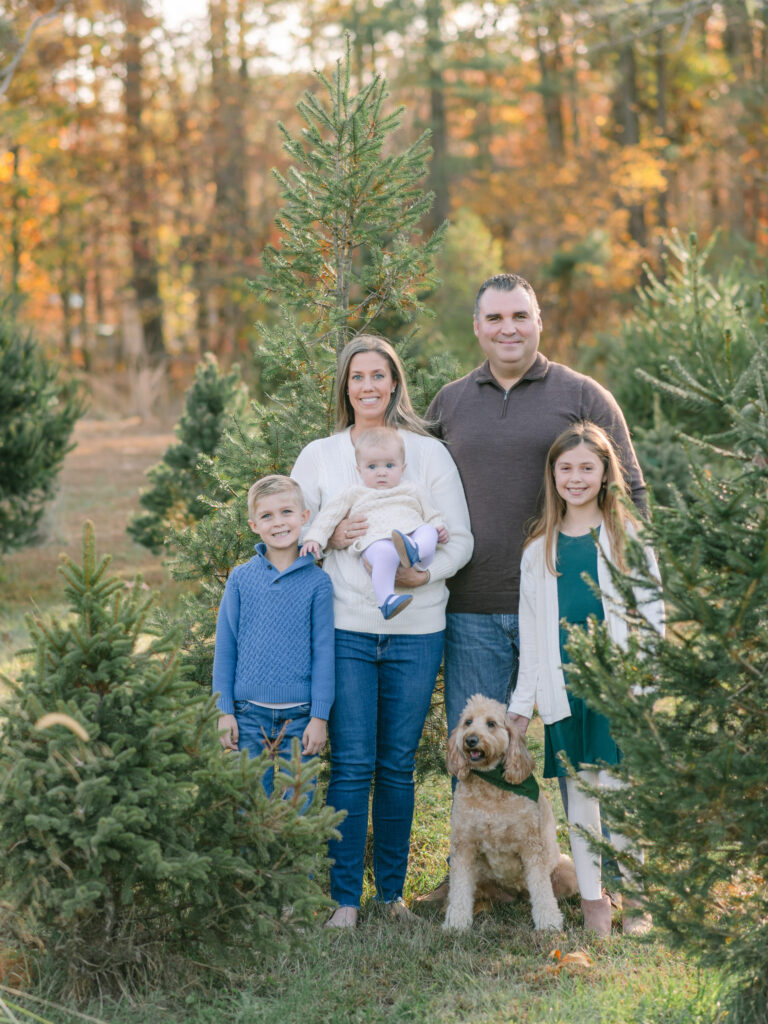 Beautiful family from Southern Maryland with their golden doodle enjoying a Tree Farm photo session.
