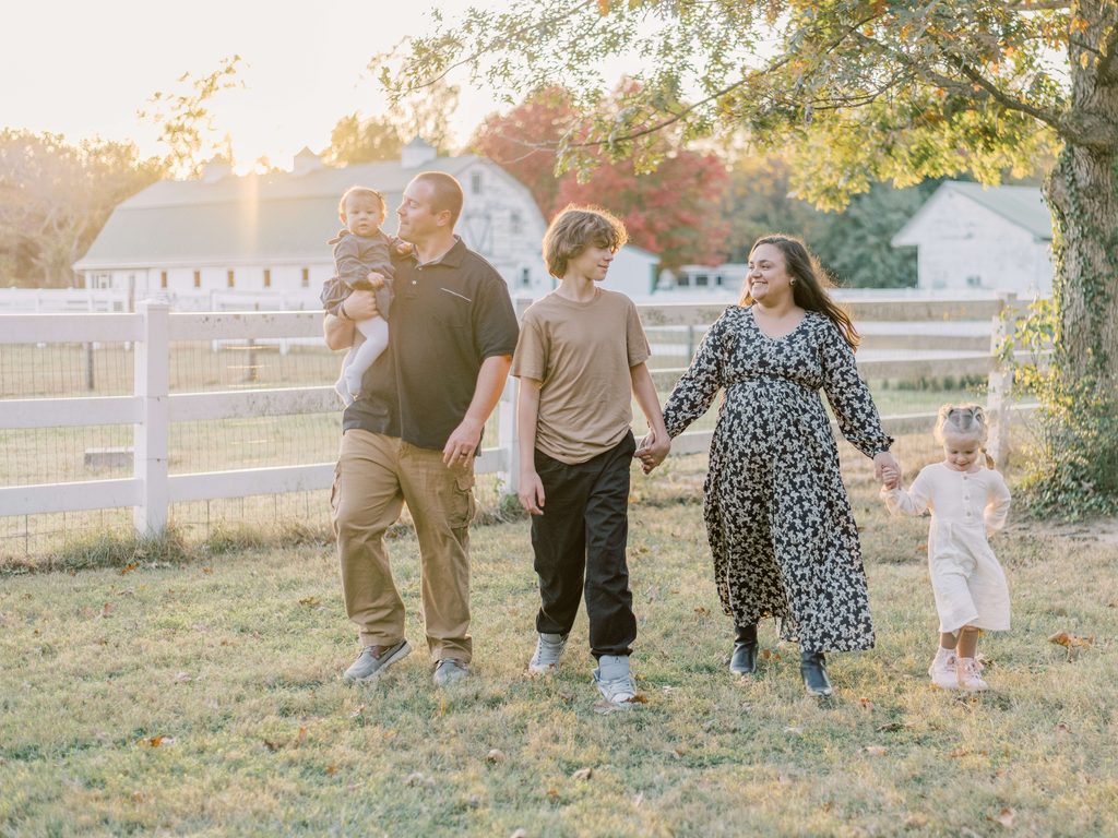 Family walking together during a fall photography session in Fredericksburg Virginia with Shelby McKimmie Photography