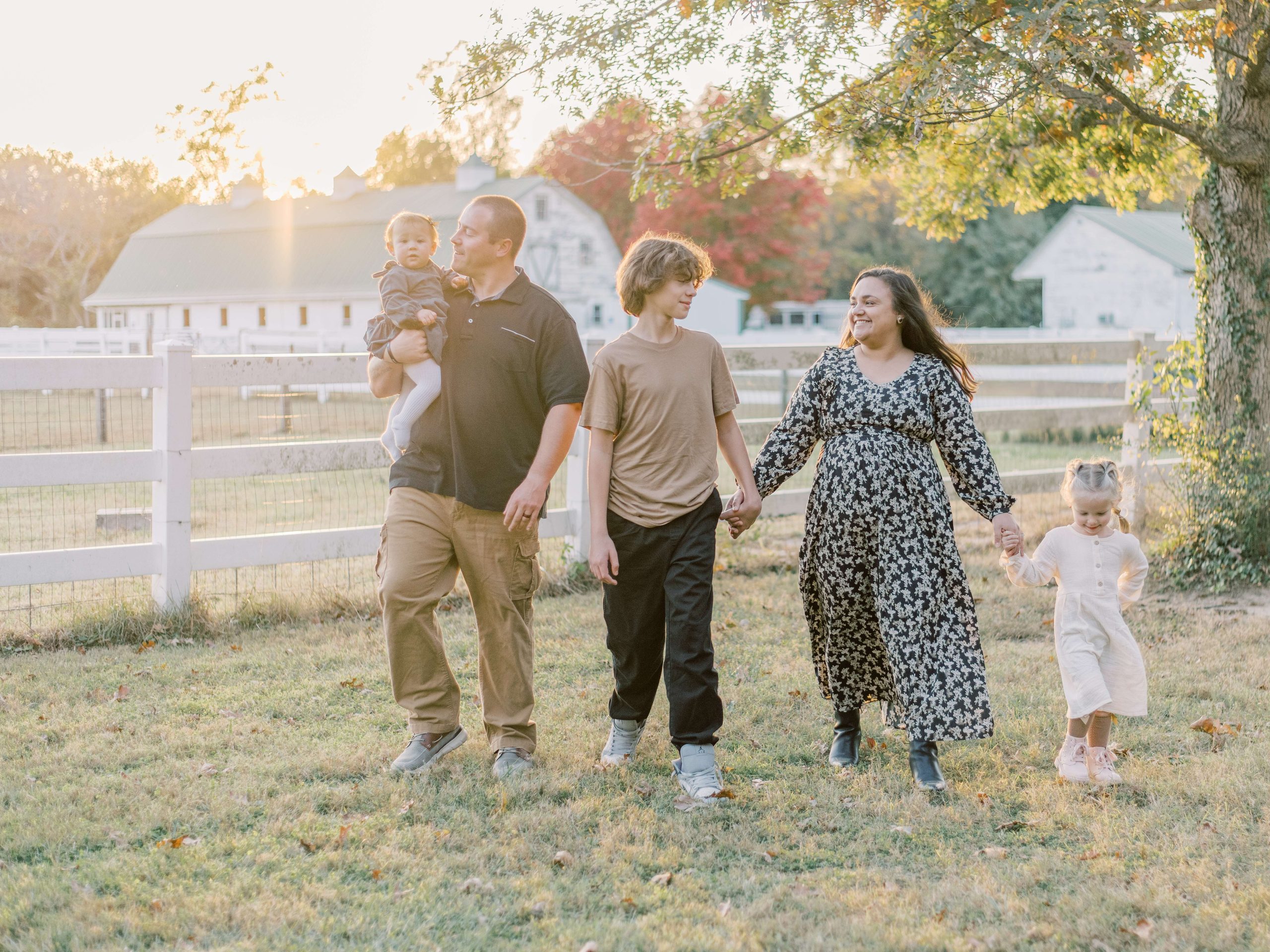 Family walking together during a fall photography session in Fredericksburg Virginia with Shelby McKimmie Photography