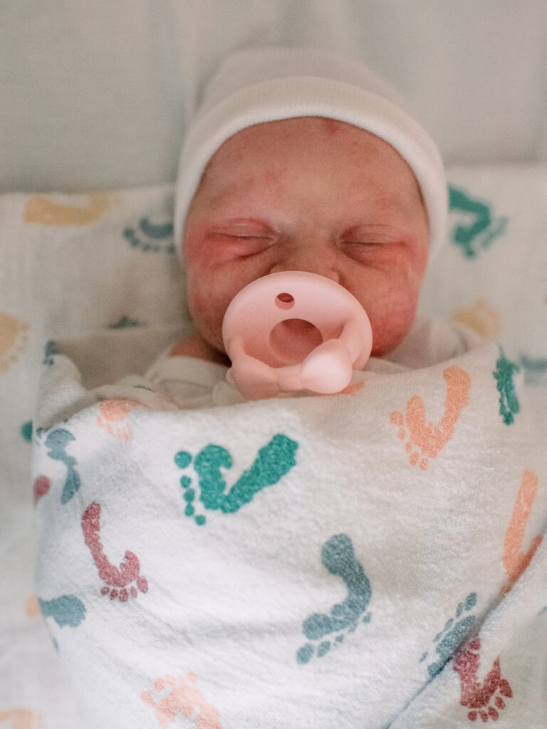 Newborn baby in hospital blanket with pacifier in St. Mary's County Hospital.