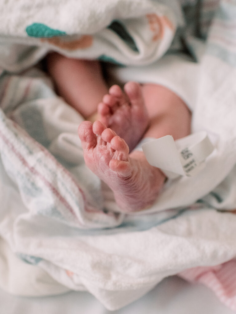 Newborn baby feet girl during her fresh 48 session.