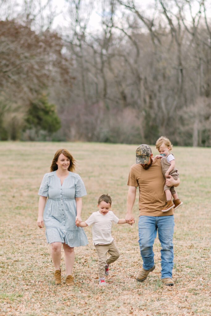 Family holding hands and walking during their King George, VA family session.
