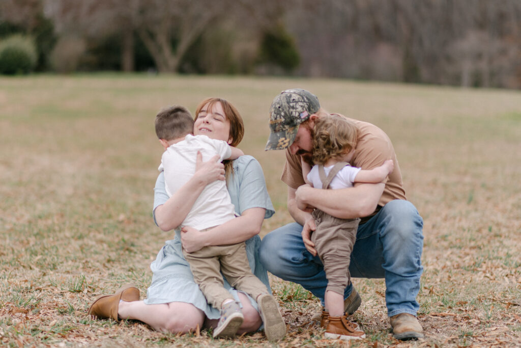 Little boys hugging their Mom and Dad at Caledon State Park.
